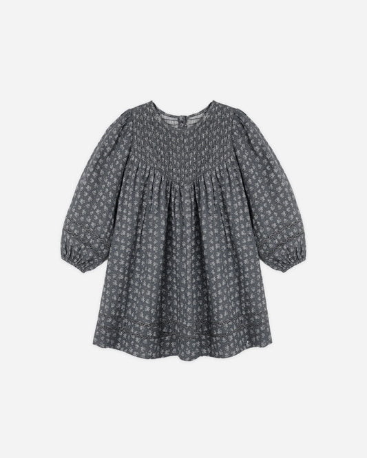 Rylee + Cru Selene dress in heart ditsy print on charcoal, flat lay front view showing the gathered yoke and long sleeves