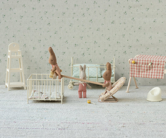 Maileg My Rabbit in stripes in a styled nursery scene with a miniature crib, highchair and gingham table