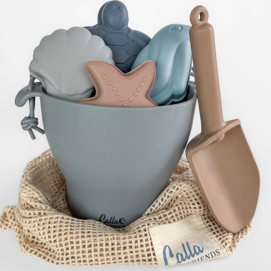 Bodhi Silicone Beach Bucket Set. Each set includes: 1 bucket, 1 small shovel, 4 sand molds; an organic cotton storage bag. Set is Non-Toxic, BPA Free, Phthalate Free, PVC Free, Lead Free.