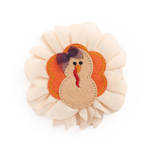 Chiffon Thanksgiving hair clip featuring multicolor turkey motif. The turkey has a small chiffon hair bow on her head. Ribbon-covered alligator clip to grip the hair.