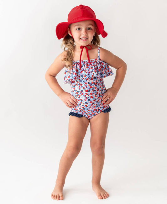 A red swim hat for babies and toddlers with a brim and a tie. The hat has built in UPF 50+ sun protection.