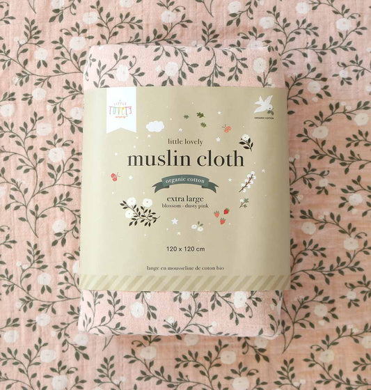 Package of 'little lovely' muslin cloth on a floral patterned background