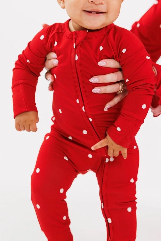 Baby standing in the Ruby Polka Dot bamboo zipper romper