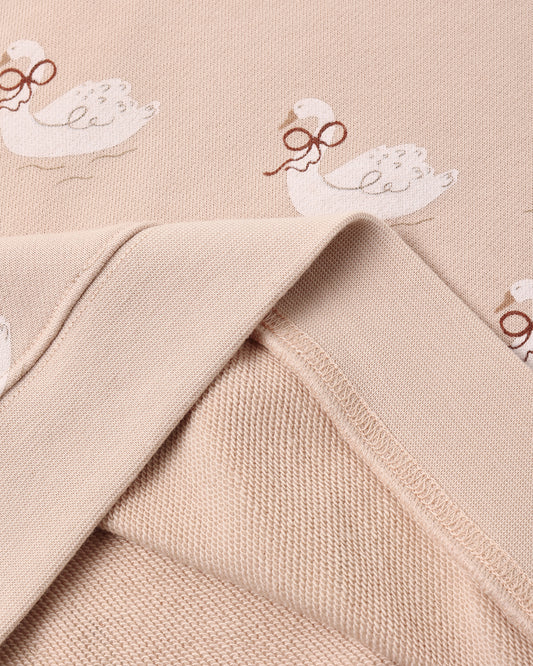 Fabric detail of the Rylee + Cru swans boxy pullover showing the swan print and soft knit inside