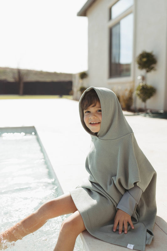 Boy wearing Waffle Beach Poncho - Sage Green hooded towel