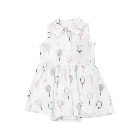 A sleeveless pink tennis tank bodysuit dress with a collar, featuring tennis racket patterns and a ruffled skirt.
