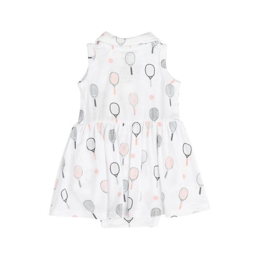 A sleeveless pink tennis tank bodysuit dress with a collar, featuring tennis racket patterns and a ruffled skirt.