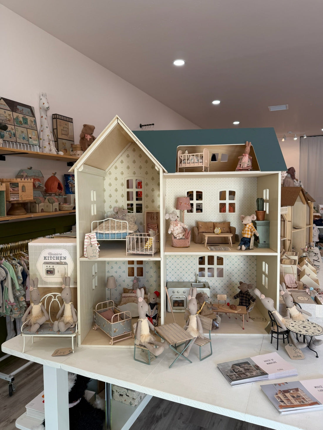 A furnished Maileg dollhouse with mice, beds and kitchen furniture on display at Shop Little Cousins in Atascadero, California