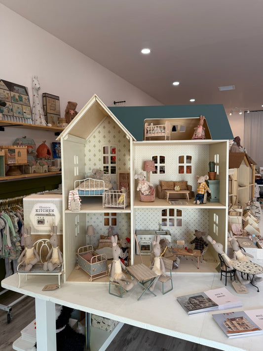 A furnished Maileg dollhouse with mice, beds and kitchen furniture on display at Shop Little Cousins in Atascadero, California