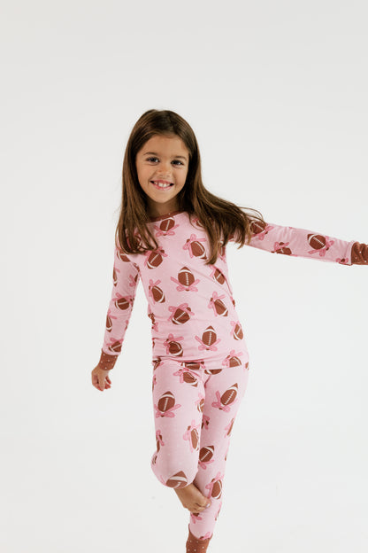 In My Jammers Game Day Bows two piece bamboo pajama set in pink football bow print, front view