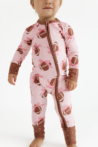 In My Jammers Game Day Bows bamboo zipper romper in pink football bow print, front view