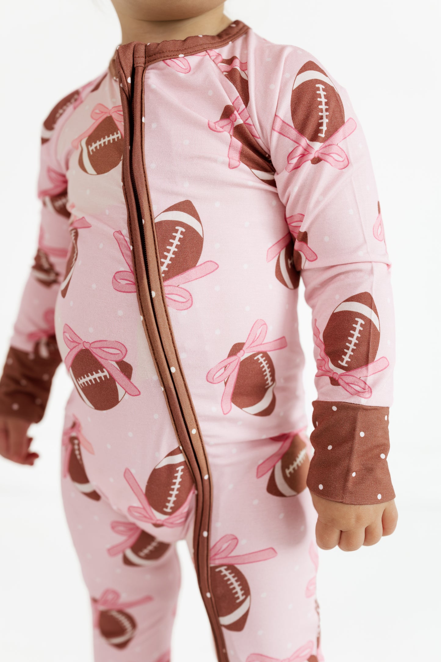 Close up of the double zipper on the Game Day Bows bamboo romper for babies