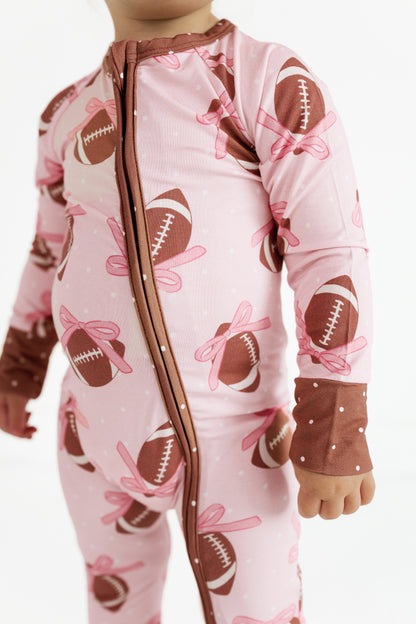 Close up of the double zipper on the Game Day Bows bamboo romper for babies
