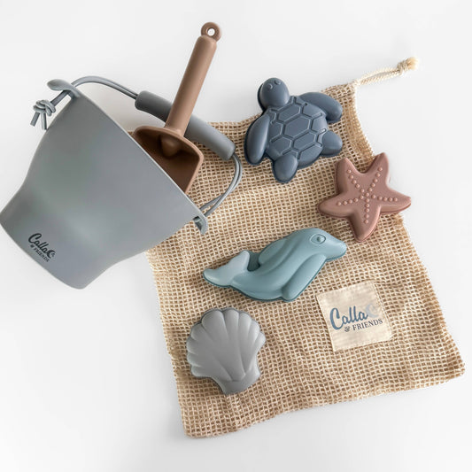 Bodhi Silicone Beach Bucket Set. Each set includes: 1 bucket, 1 small shovel, 4 sand molds; an organic cotton storage bag. Set is Non-Toxic, BPA Free, Phthalate Free, PVC Free, Lead Free.