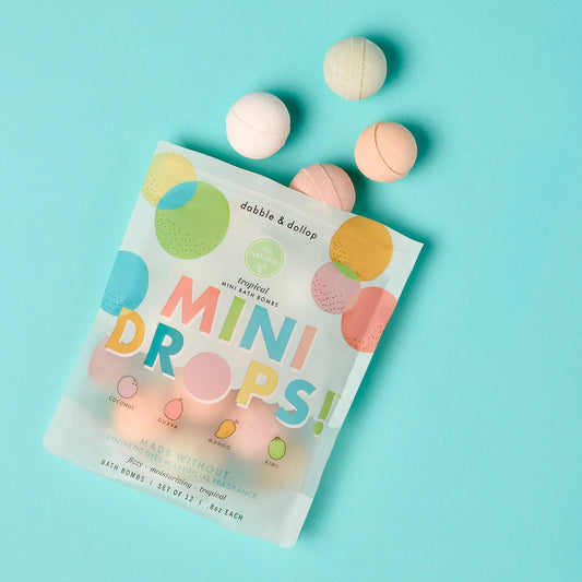 Package of dabble & dollop tropical scent mini bath bombs on a light blue background