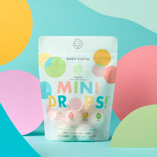 Packaging of 'Mini Drops' tropical scented bath bombs with colorful design on a blue background