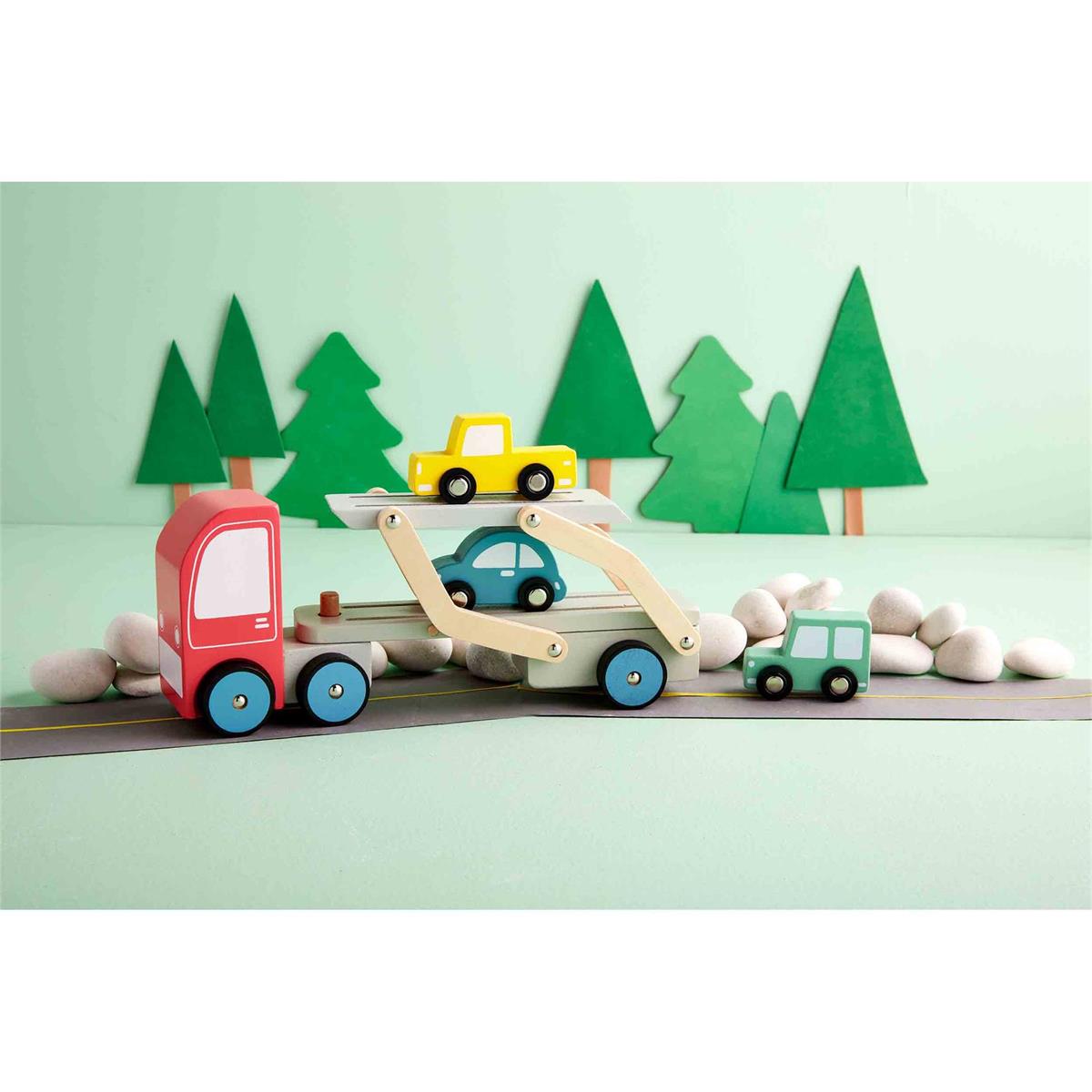 Four Piece Car Carrier Truck Toy Set. The play set comes with a large wooden carrier truck and three smaller wood cars of varying colors - yellow, green and blue. This set is intended for children ages 3 and older. The set arrives in a gift box and is made of mango wood.