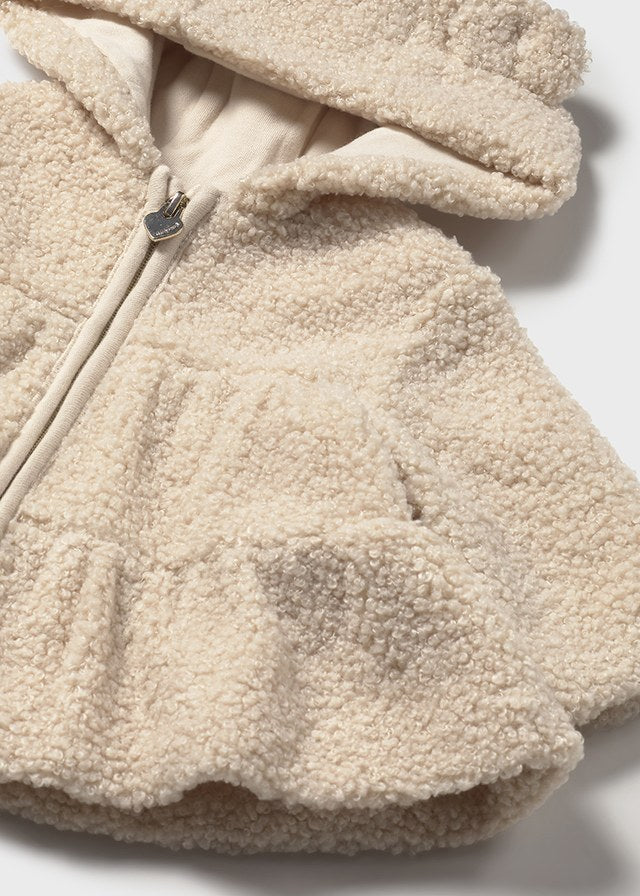 Close-up of a beige fleece jacket with a zipper on a white background