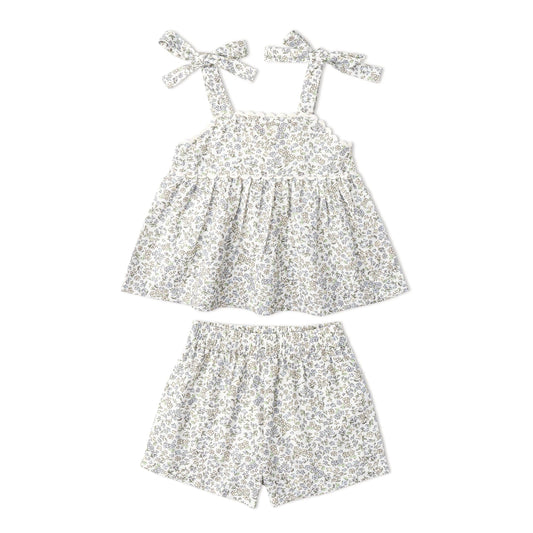 Floral romper with bow straps on a white background
