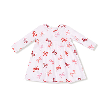 White dress with red and pink bow pattern on a white background