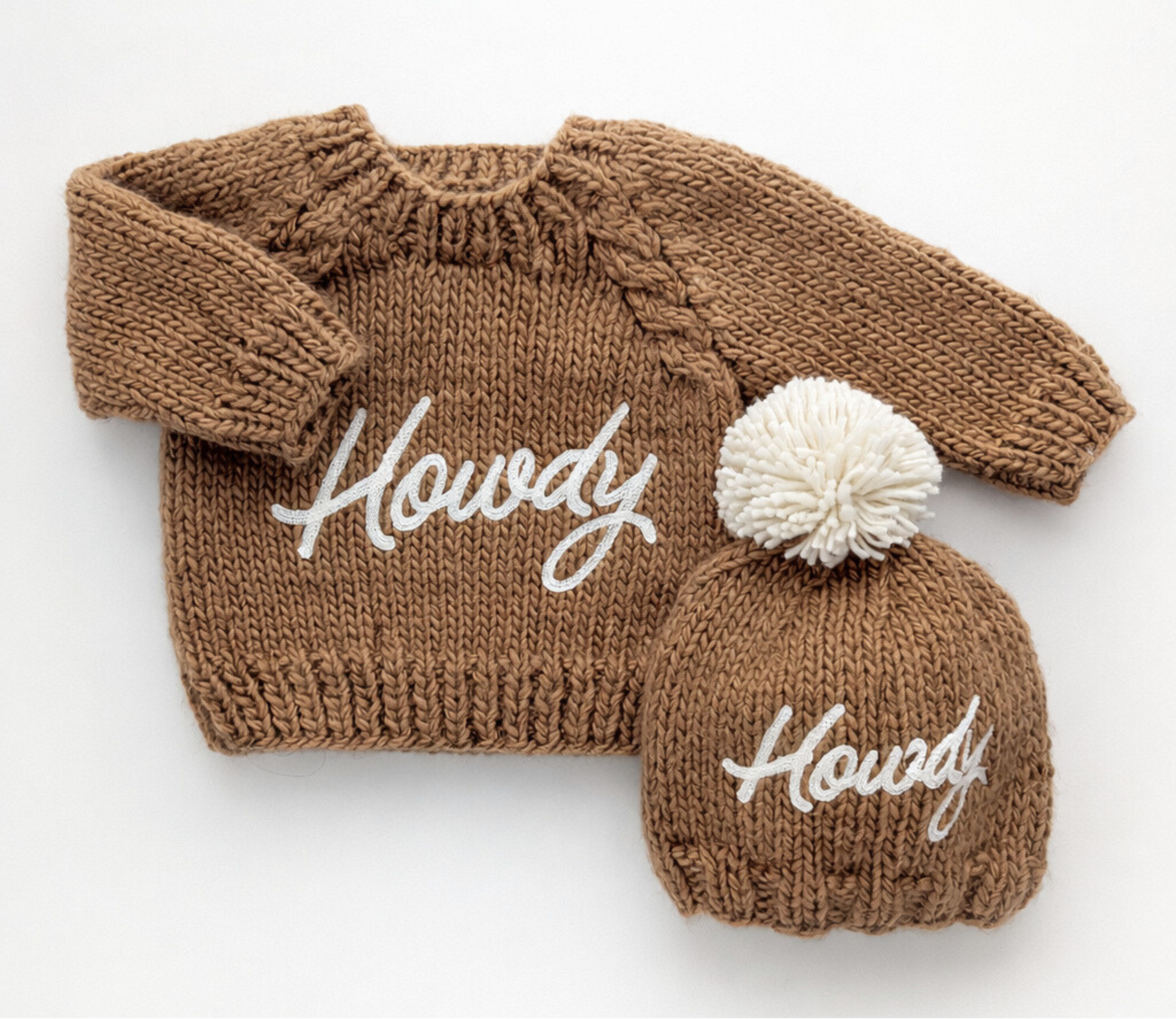 Brown knitted sweater and matching beanie with 'Howdy' text on a white background