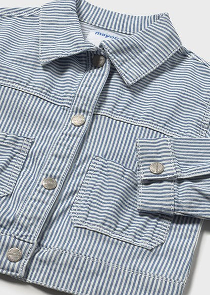 Close-up of a blue and white striped jacket with button details on a light gray background