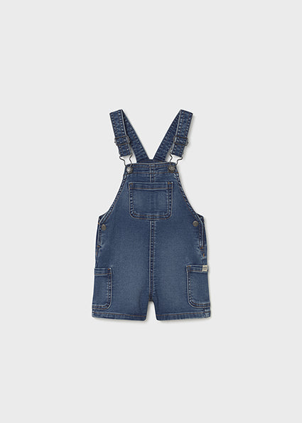 Blue denim overalls on a white background