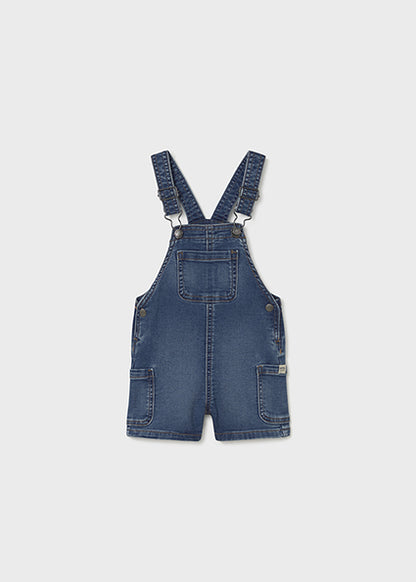 Blue denim overalls on a white background