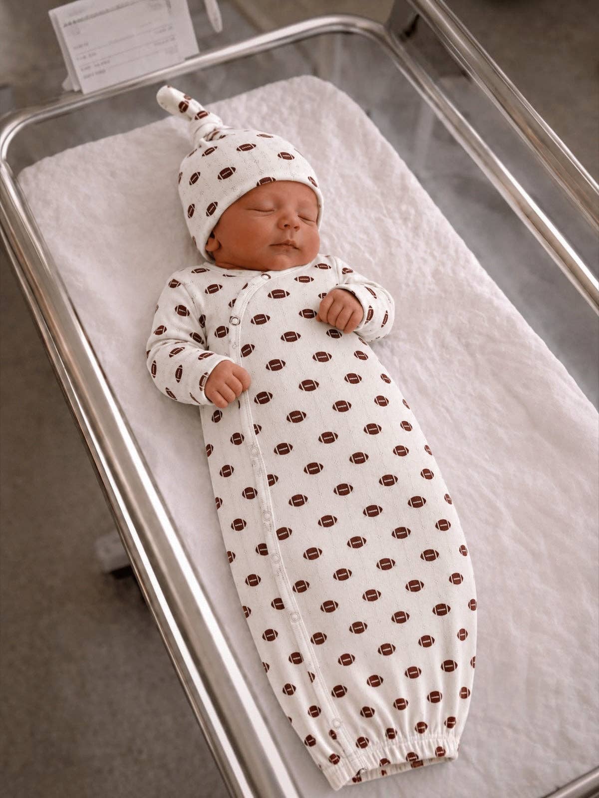 Baby in the football print organic pointelle knotted gown and matching beanie
