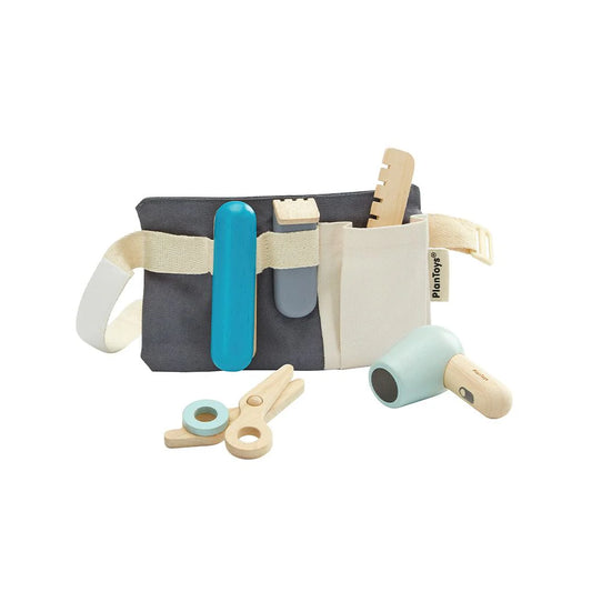 Toy hairdresser set with a belt and various hair tools on a white background
