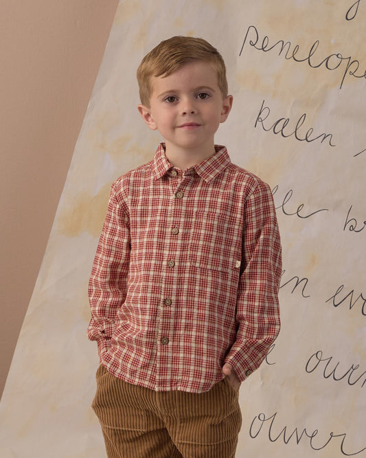 Boy with a hand in his pocket wearing the Rylee + Cru collared long sleeve shirt in red vintage plaid
