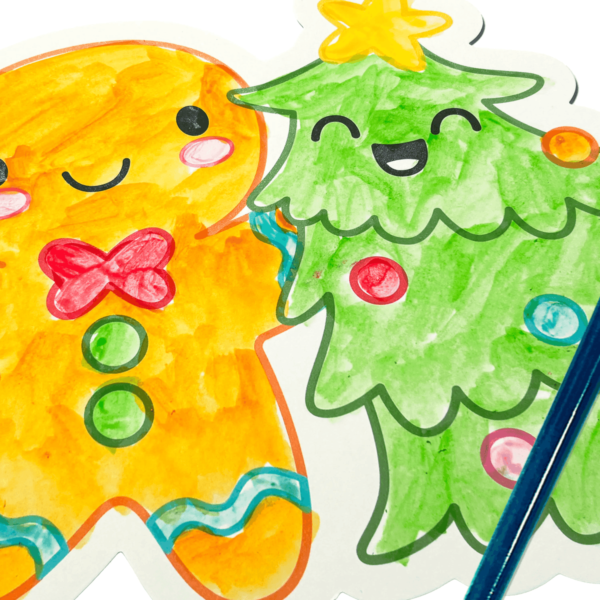 Close view of finished gingerbread and Christmas tree watercolour cards