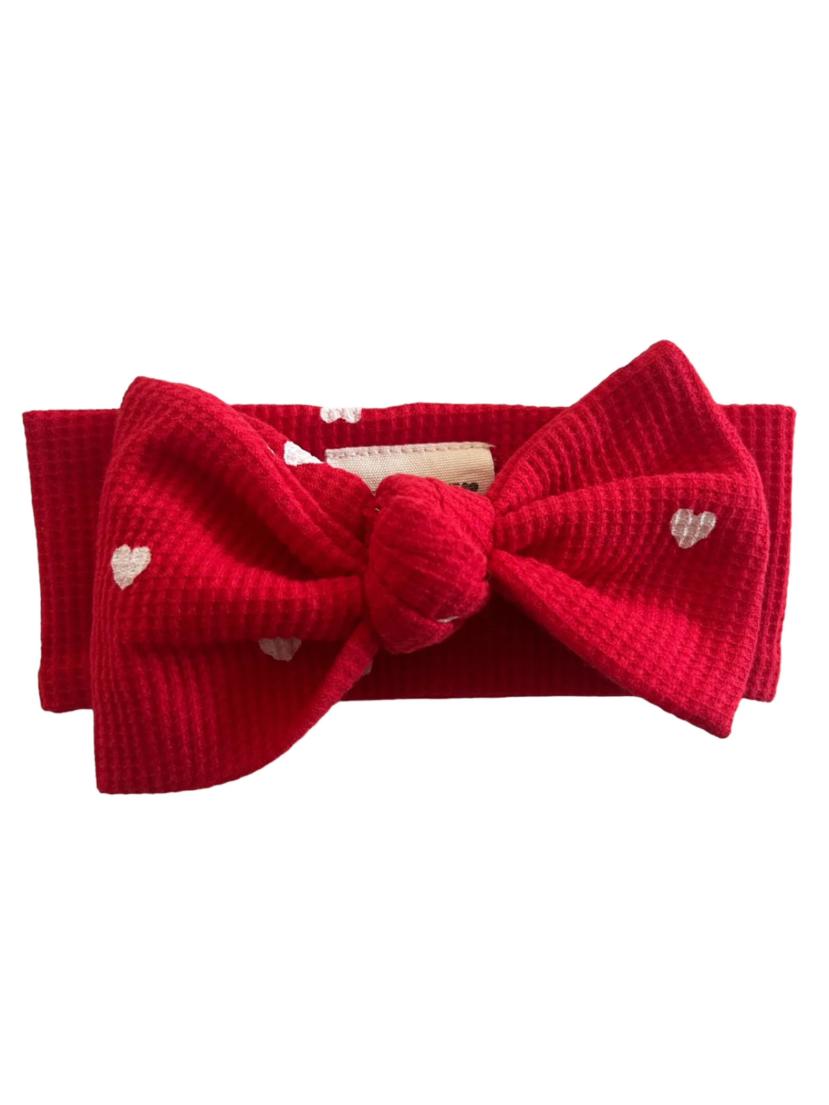 Lay flat image of our Organic Waffle Knot Bow in Little White Heart pattern with red base color. 