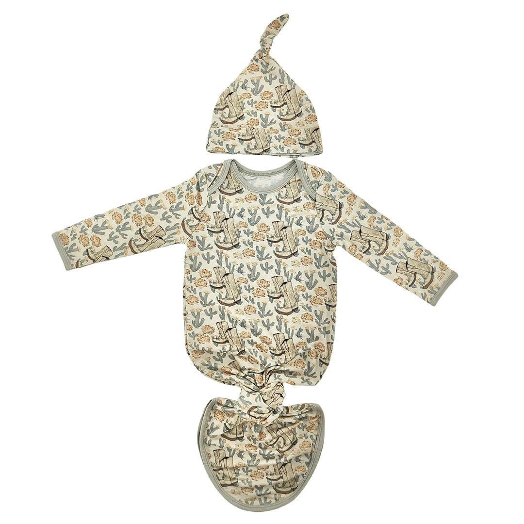 Baby outfit set with long-sleeve shirt, hat, and pants featuring a nature-themed print on a white background.