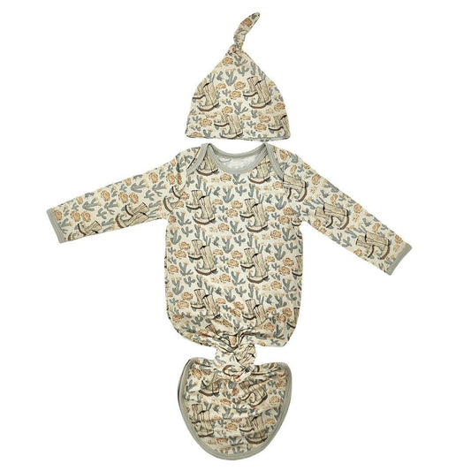 Baby outfit set with long-sleeve shirt, hat, and pants featuring a nature-themed print on a white background.