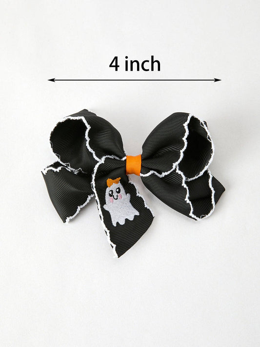A black ribbon hair bow with white tattered edges, an orange center band, and a small ghost graphic on one loop. A black measurement arrow above the bow reads '4 inch' to indicate size.