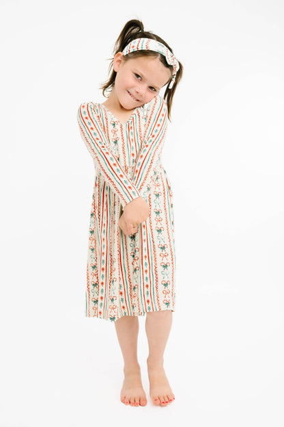 Girl wearing the Christmas Dainty Bow bamboo dress