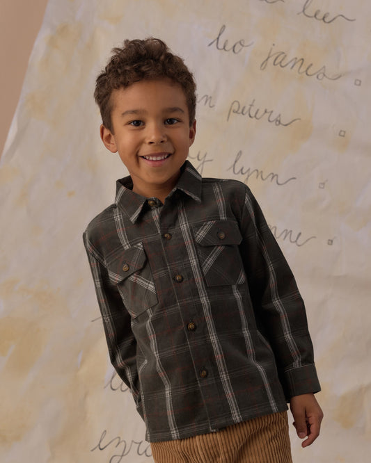 Boy smiling in the Rylee + Cru pocketed flannel shirt in holiday plaid, close view showing the chest pockets