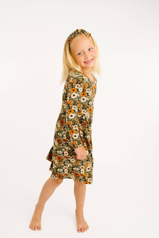 Girl wearing the Rustic Blooms bamboo dress in olive floral