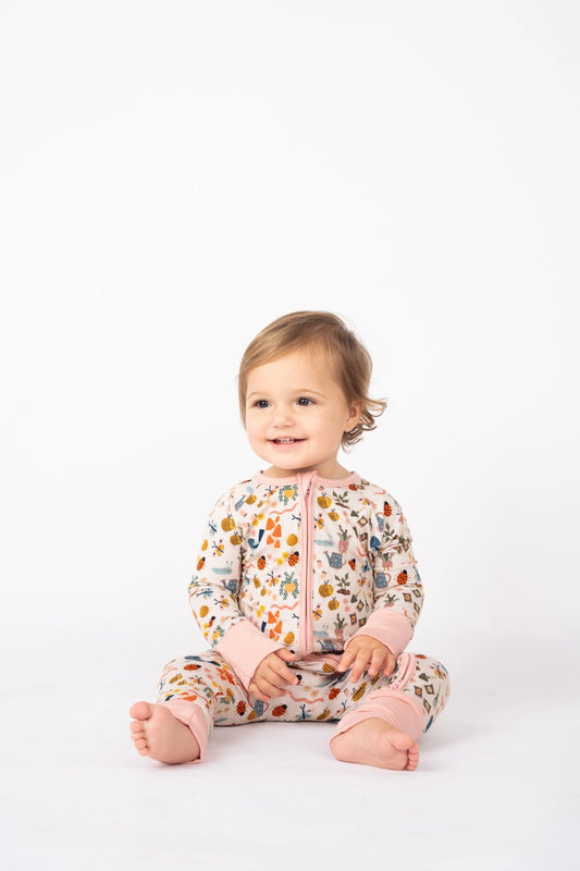 Baby wearing a floral onesie on a white background