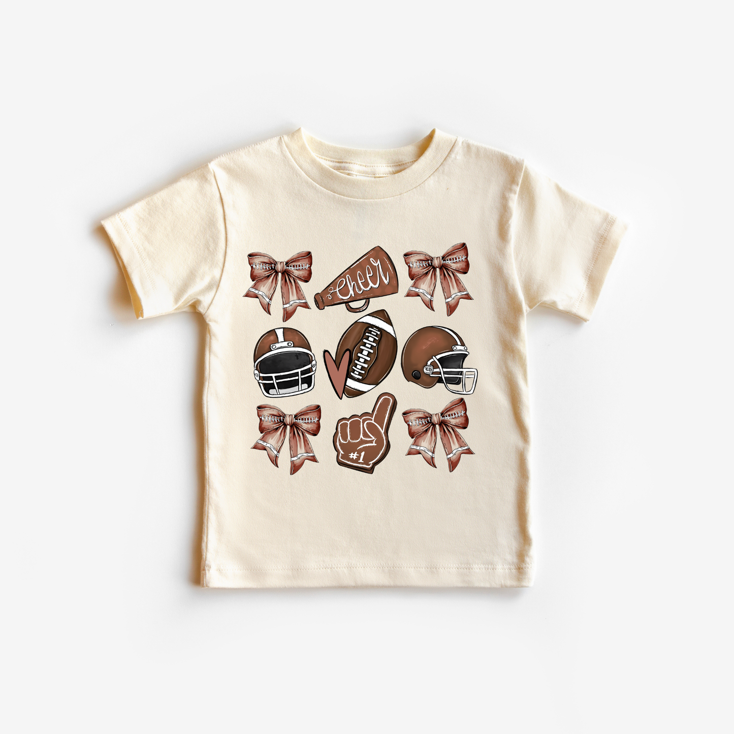 Beige t-shirt with football-themed graphics on a natural colored background