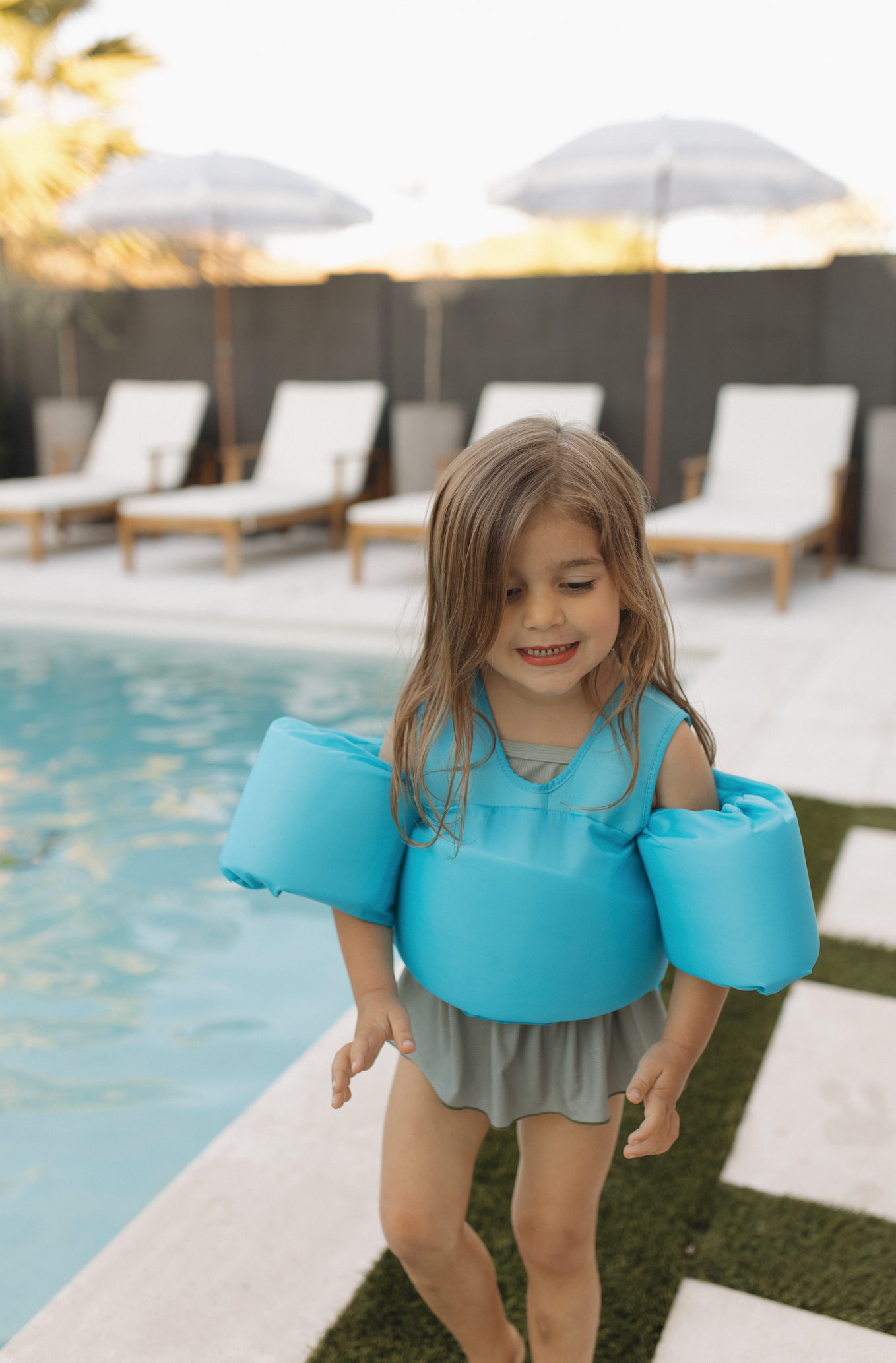 Girl wearing high visibility neon swim floatings in Blue Curaco