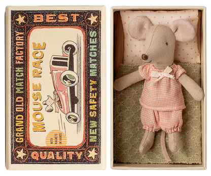 Little sister mouse wearing a pink gingham pajama set in a matchbox with a vintage-style matchbox design.