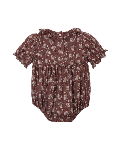 Back image of a baby romper in a dark brown color with a light beige floral pattern, featuring short ruffled sleeves and a buttoned neckline.