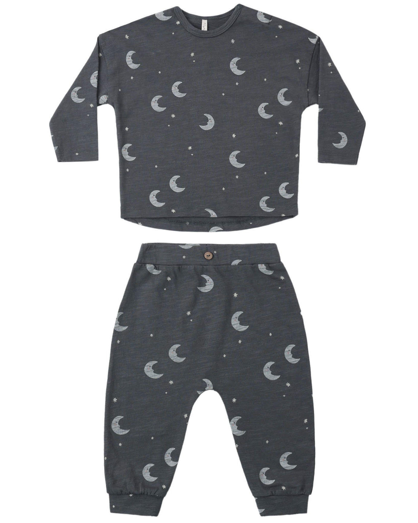 Children's midnight colored pajama set with moon and star pattern on a white background