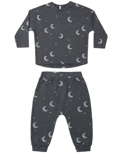 Children's midnight colored pajama set with moon and star pattern on a white background