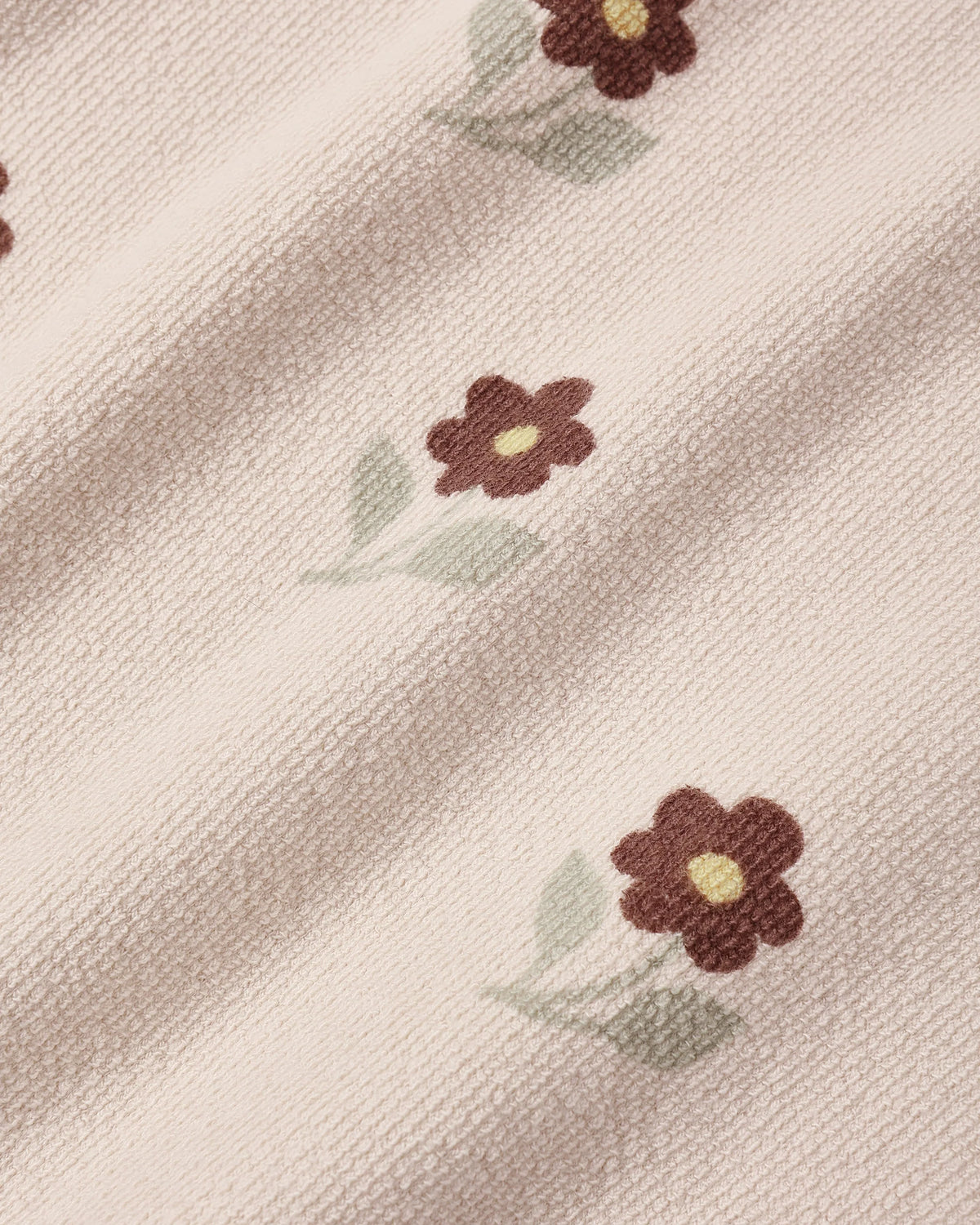 Close view of the embroidered daisies on the Rylee + Cru Petal Daisy spongey knit