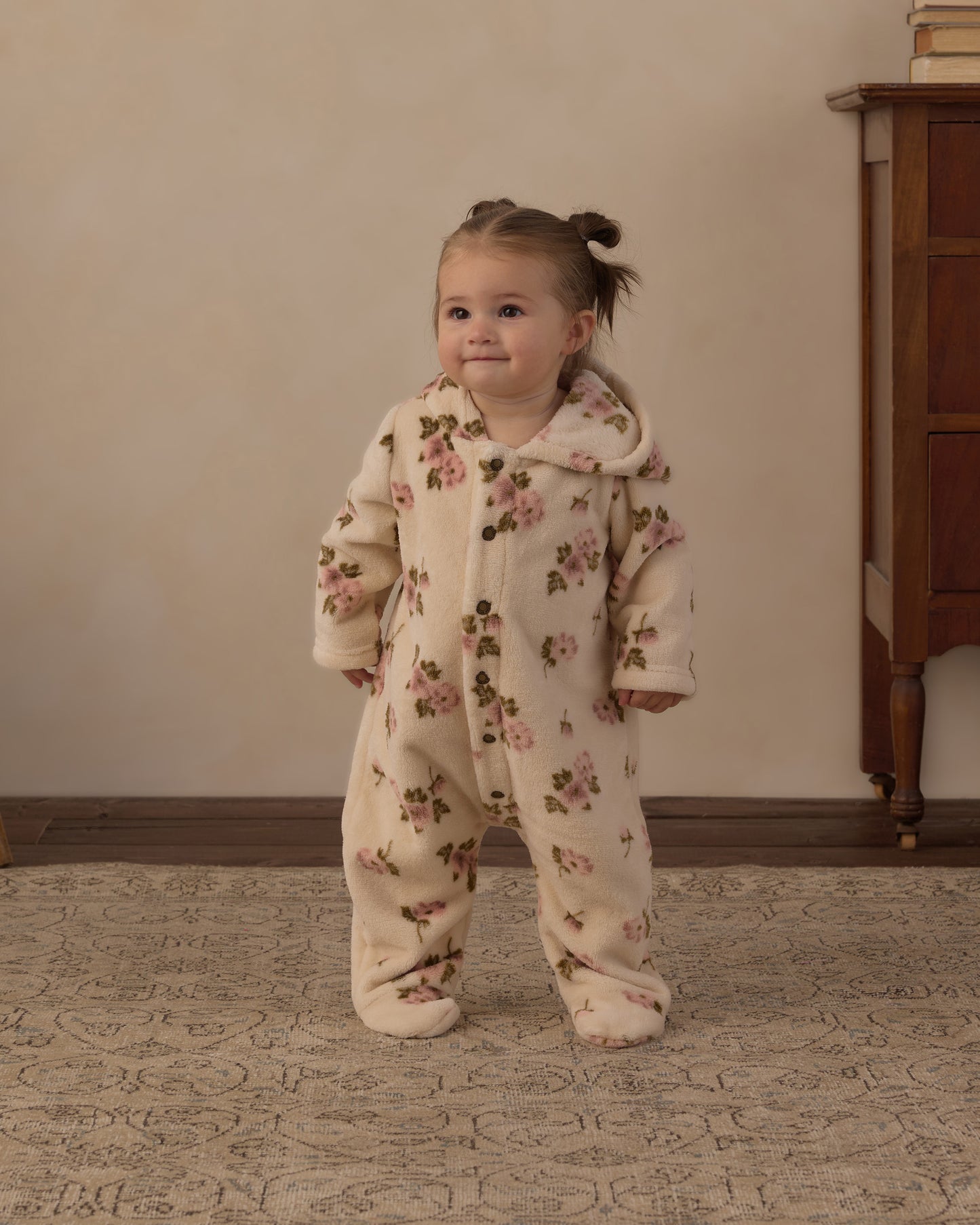 Toddler walking in the Rylee + Cru Fleece Jumpsuit in the Rose Garden print