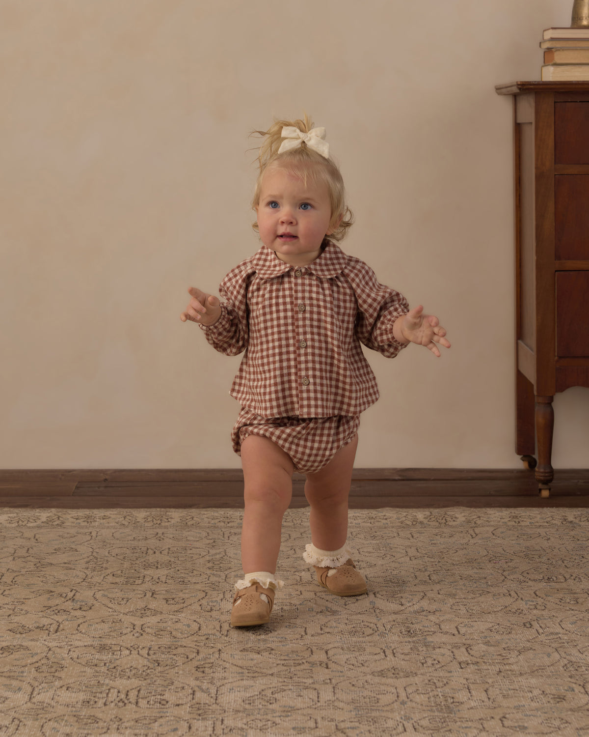 Toddler walking in the Rylee + Cru Nellie set in brick check