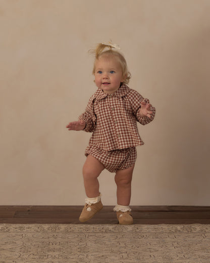 Toddler standing in the brick check Nellie set from Rylee + Cru